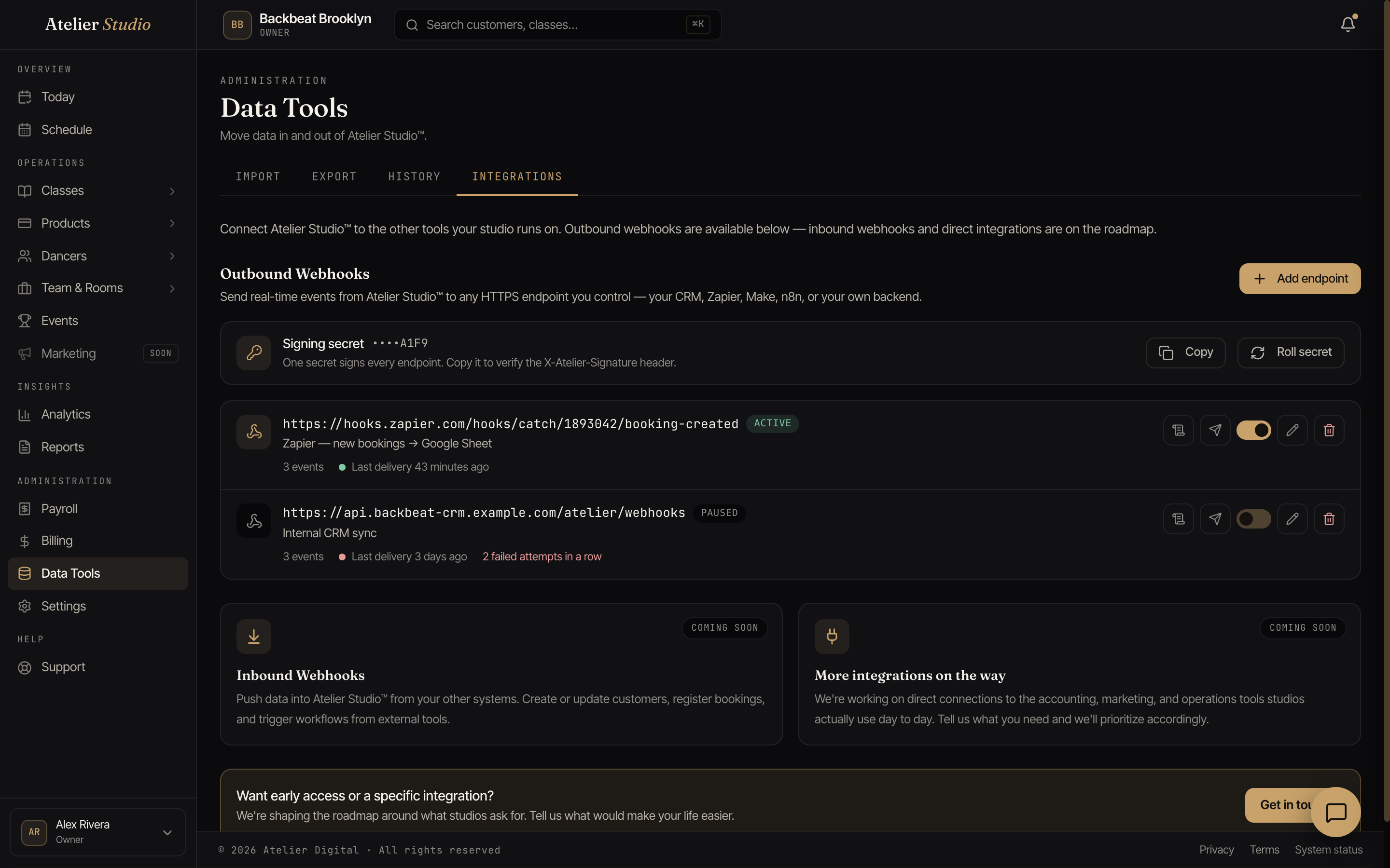The Integrations tab showing the signing secret card and a list of webhook endpoints, each with a status pill and last-delivery indicator.