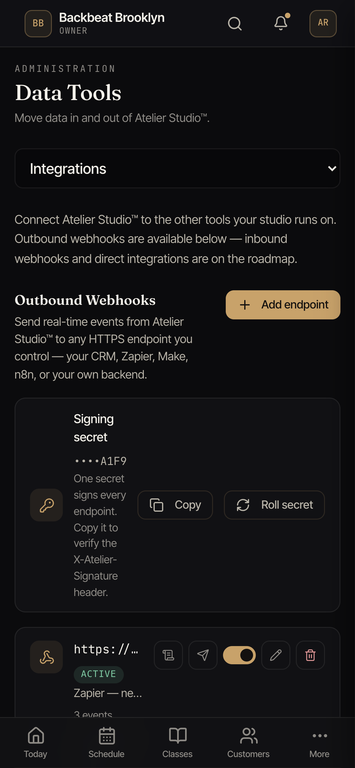 The Integrations tab showing the signing secret card and a list of webhook endpoints, each with a status pill and last-delivery indicator.